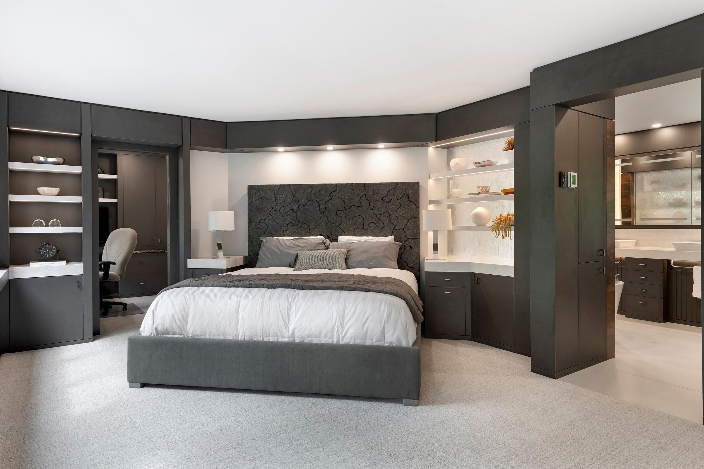 Modern bedroom with gray furniture and elegant decor.