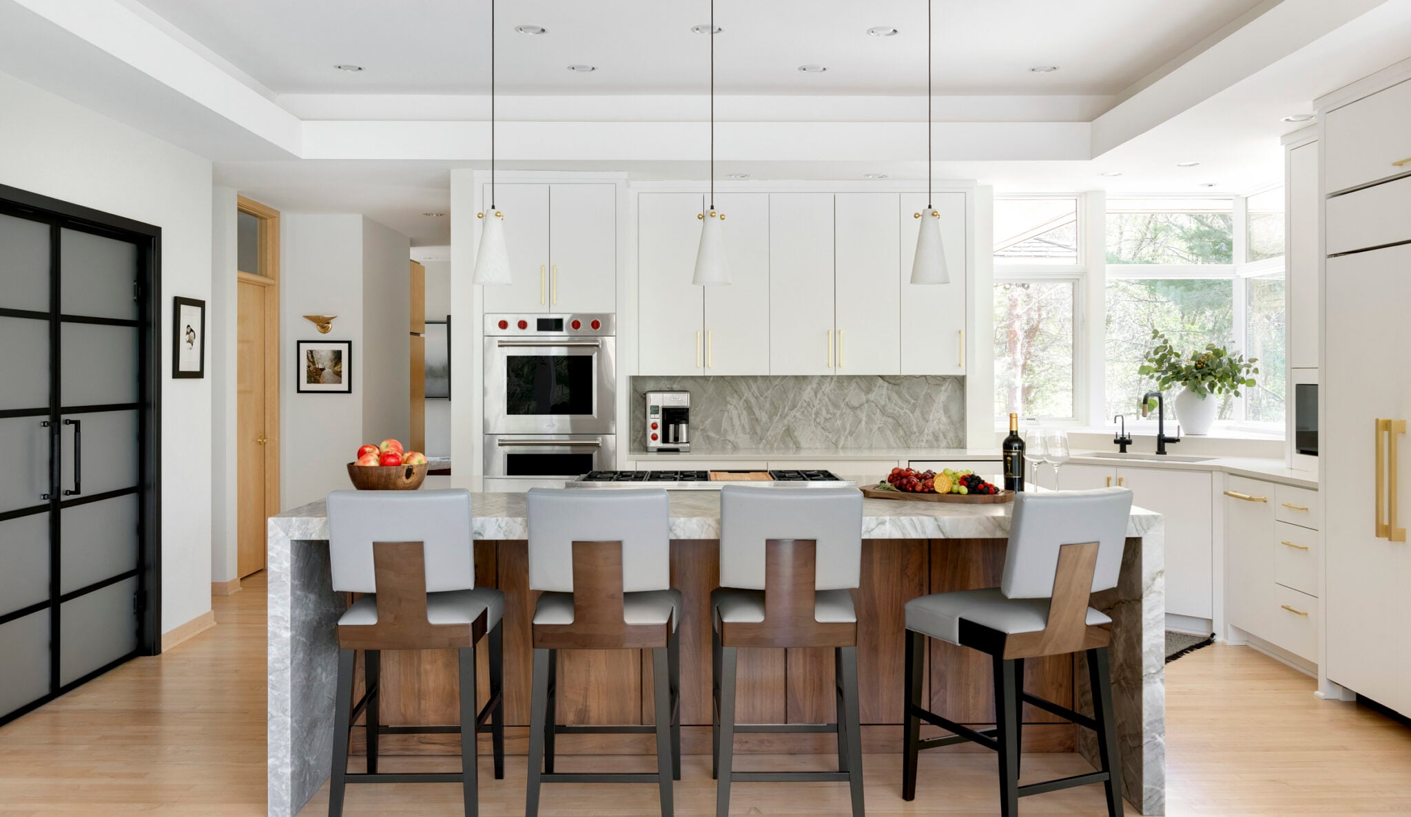 Modern kitchen with island and bar stools.